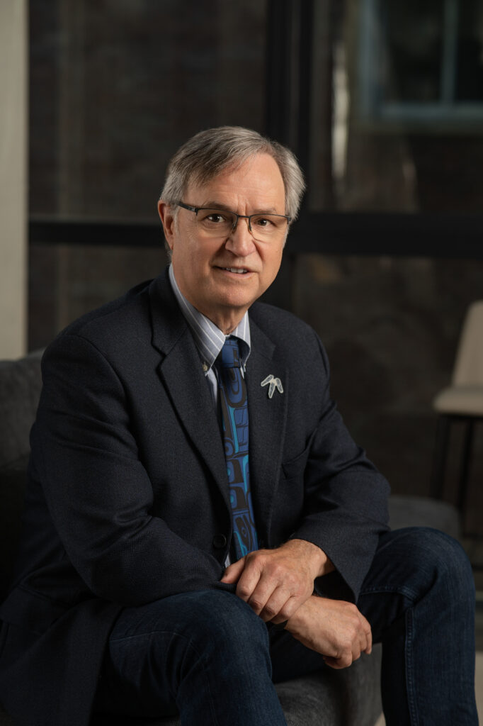 George Abbott, commissioner from BC Treaty in a suit sitting confidently with office background