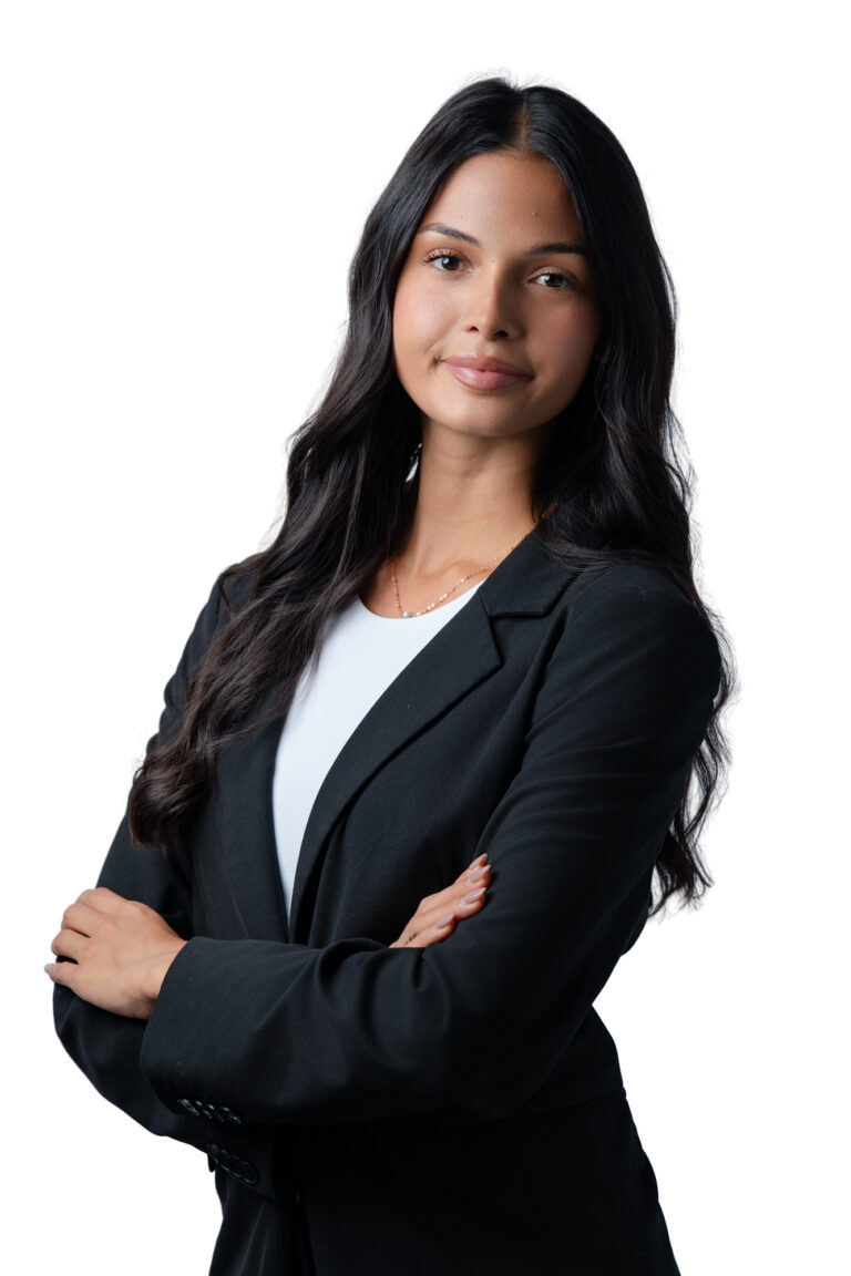 Lawyer headshot of a female lawyer with crossed arms looking at the camera with a slight tilt