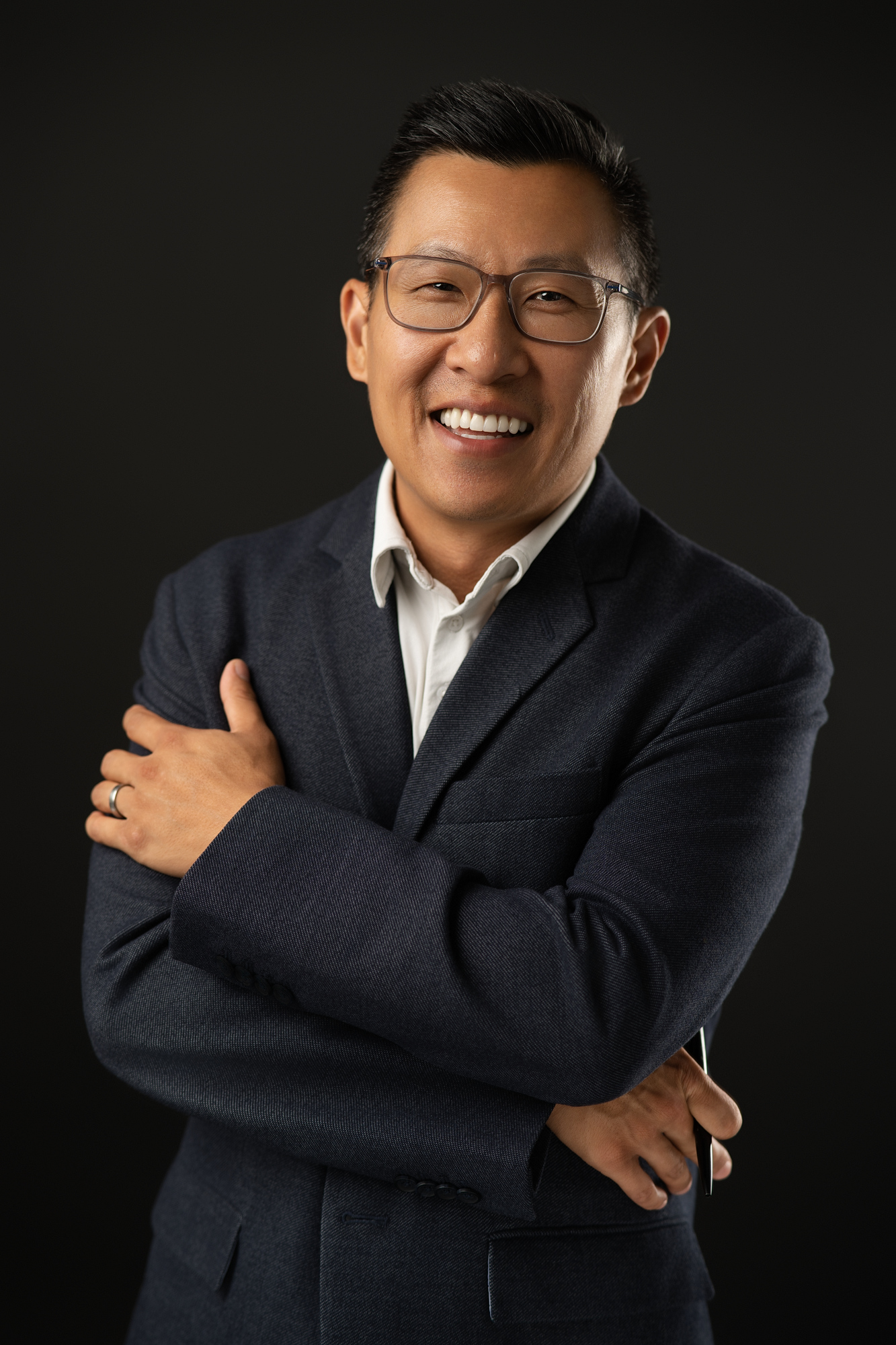 Personal branding photography of Chris Ho with arms crossed