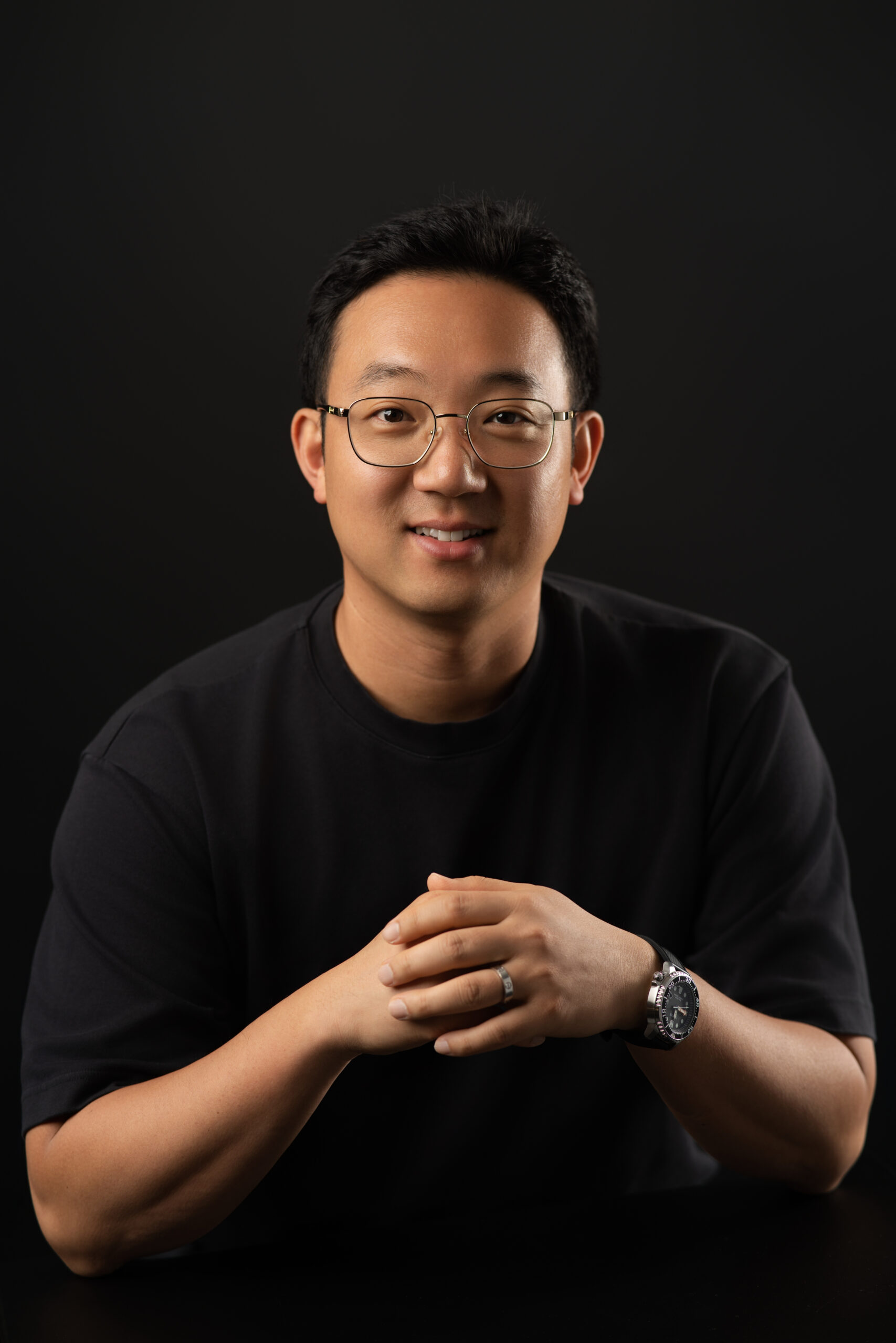 Male tech posing with hands clasped together