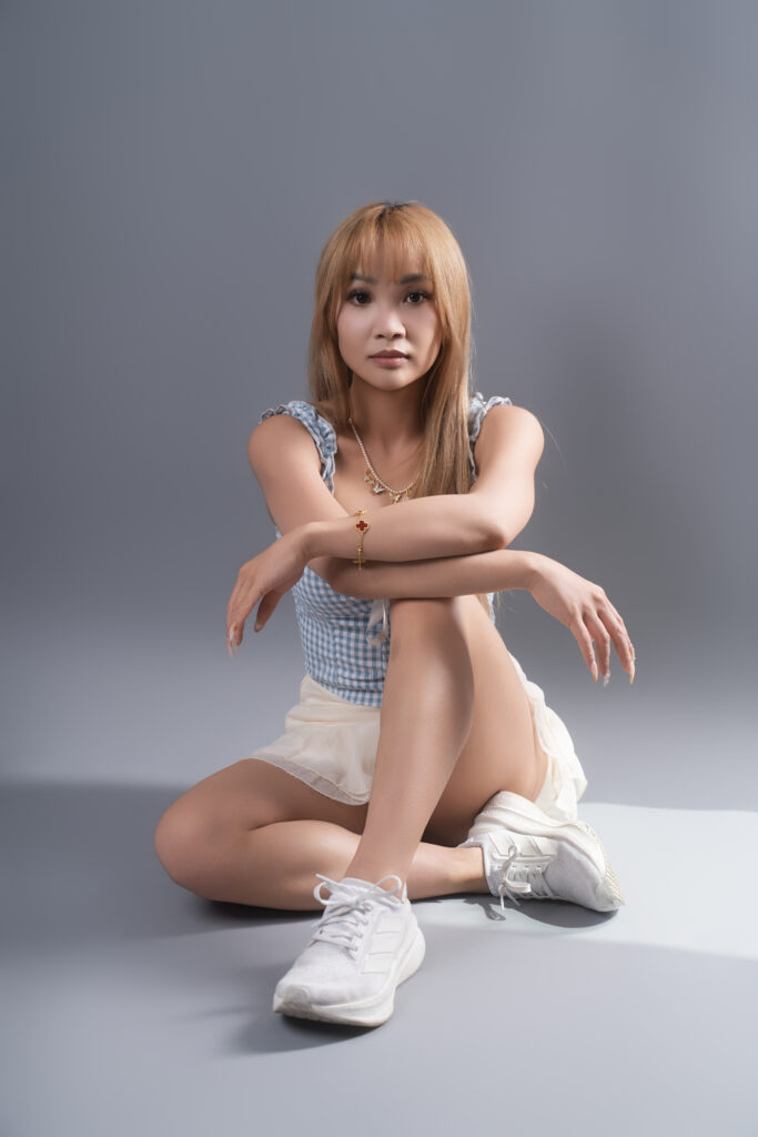 Elaine Li, Vancouver influencer and model, seated on the floor in a casual athletic outfit for a personal branding session.